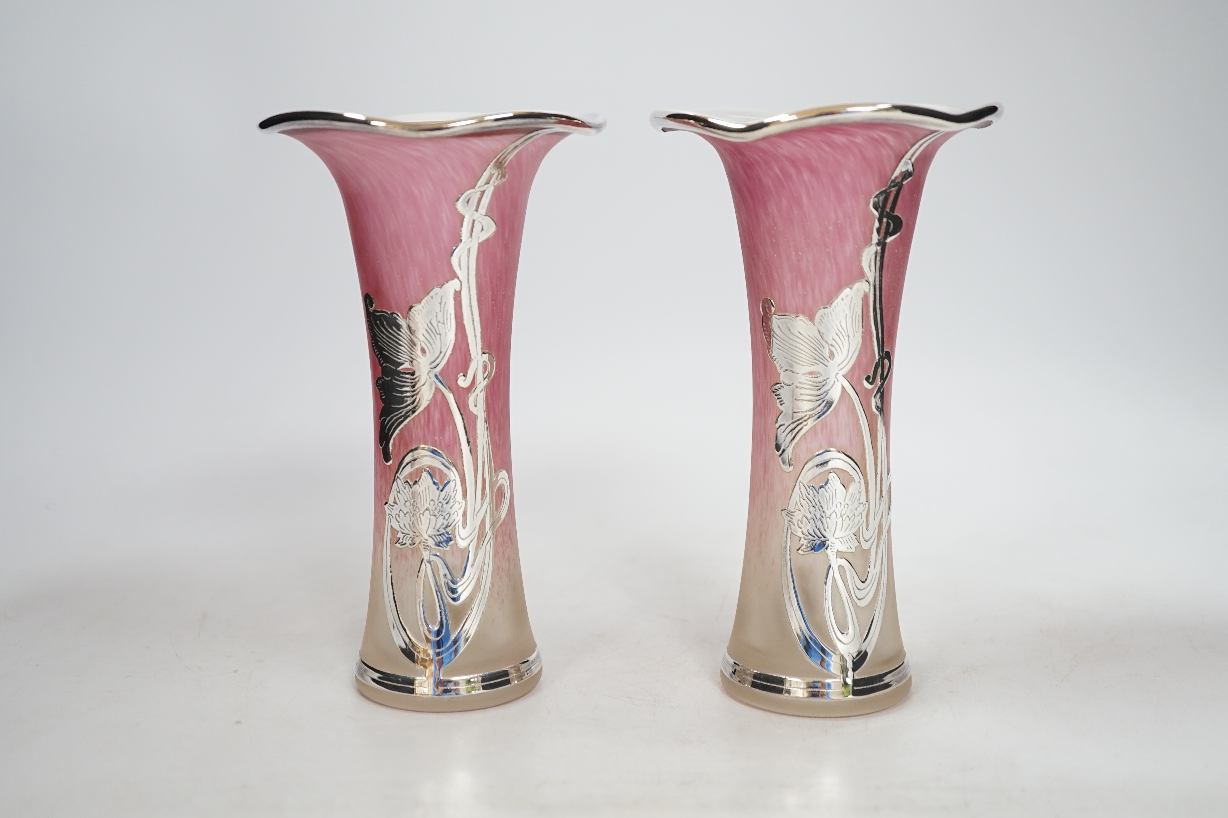 A pair of Loetz style pink tinted opaque glass specimen vases applied with silver overlaid floral decoration, height 16cm